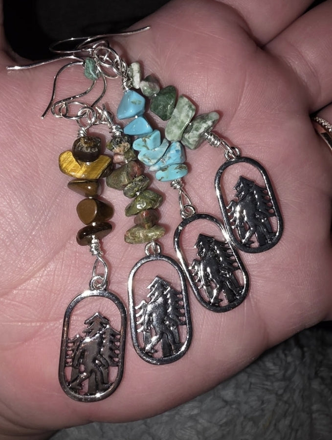 Four pairs of dangle earrings with Chip Stones (Tigers Eye, Unakite, Tourquoise and Moss Agate) each with a Bigfoot Charm at the end on Sterling Silver Hooks)